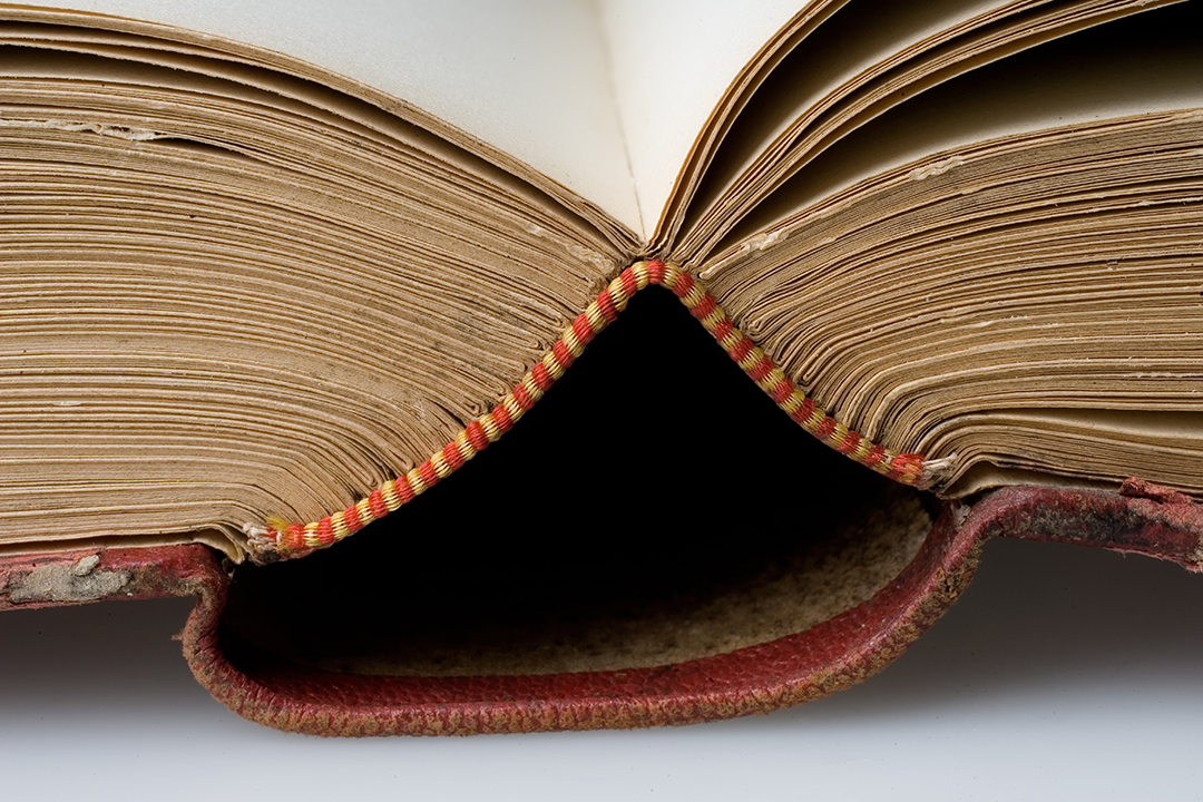 A stock photo of an aged book's bindings.